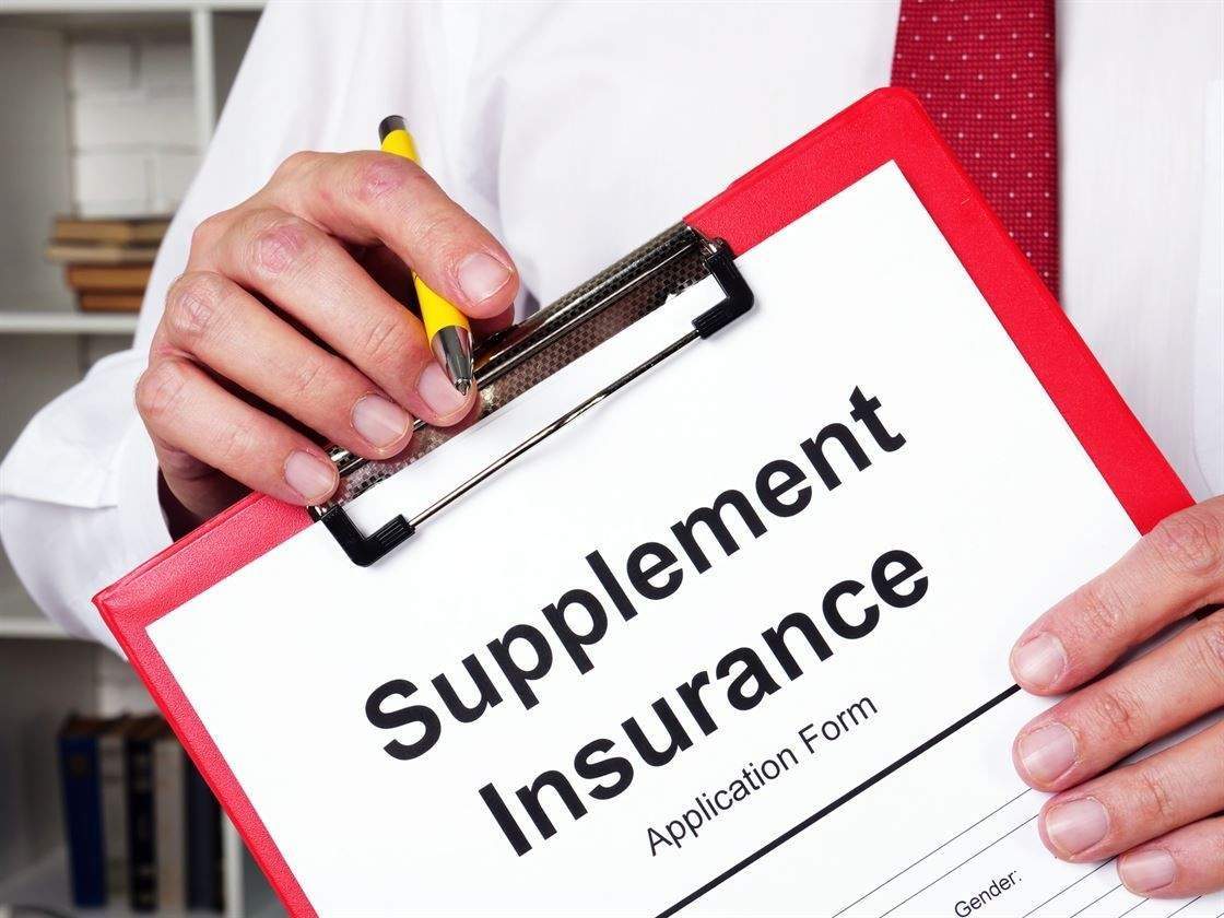 A red clipboard holding a supplement insurance application form
